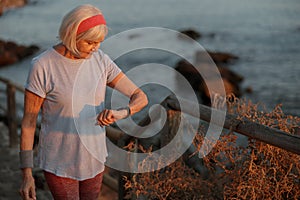 Caucasian elderly woman at daily fitness regime outdoors