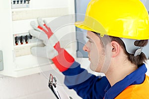 Caucasian electrician repairing a power plan