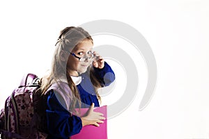 Caucasian elementary age schoolgirl with glasses posing in unifo