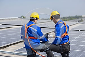 Caucasian engineer checking on solar panel on the rooftop