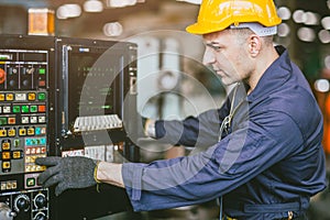 Caucasian Engineer Male Skill Worker Working Operate CNC Lathe Machine In Metal Factory