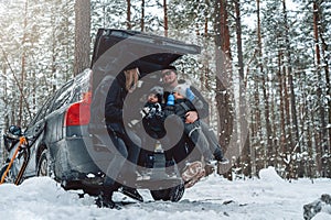 Caucasian family having a good time together in winter forest