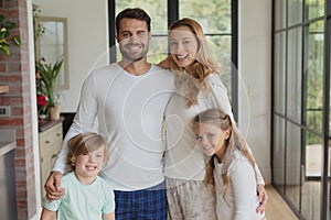 Caucasian family looking at camera while standing