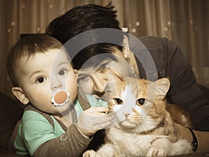 Caucasian family mother and baby playing with cat