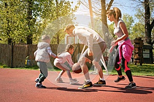 Caucasian family playing basketball together.