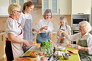 Caucasian family preparing delicious tasty pizza in bright modern kitchen