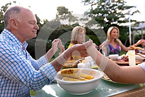 Caucasian family saying grace together before eating