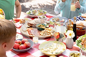 Caucasian family sitting at table during a family lunch in the garden