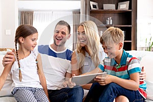 Caucasian family with two children using a tablet computer at home