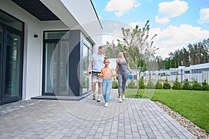 Caucasian family walking on terrace near townhouse before workout outdoors