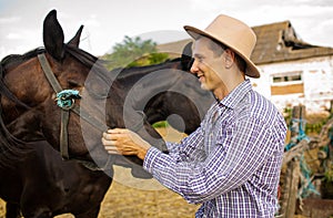 Caucasian Farmer Leaning On Railing Near Horse