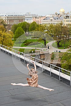 Caucasian fashion ballerina leaping on the roof