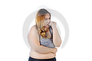 Caucasian fat woman biting her fingernails