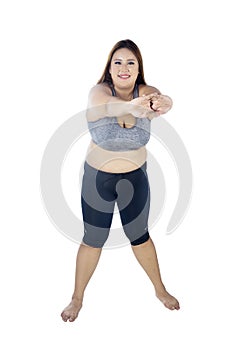 Caucasian fat woman doing warm up on studio