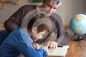 Caucasian father and son doing mathematics homework