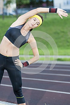 Caucasian Female in Athletic Sportgear Having Stretching Excercises Outdoors
