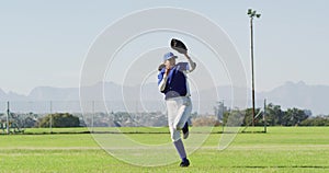 Caucasian female baseball player, fielder jumping, catching and throwing ball on baseball field