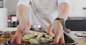 Caucasian female chef teaching diverse group wearing face masks