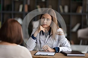 Caucasian female doctor consult mature patient in clinic