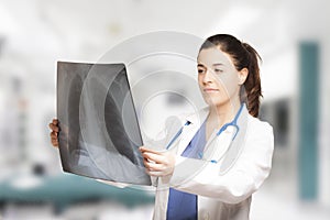 Caucasian female doctor looking at a radiography