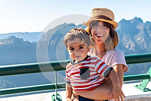 Caucasian female with her son at the Miradouro do Paredao viewpoint, Madeira. Portugal