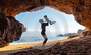 Caucasian female with her son in the natural cave in the Algarve at Praia da Coelha, Albufeira