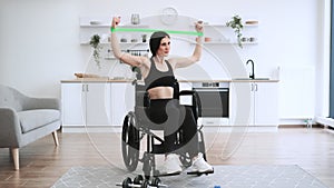 Caucasian female with mobility impairment doing exercises with stretching bands