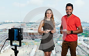 Caucasian female presenter and latin man at tv studio