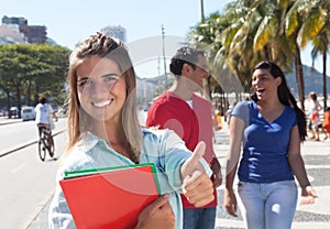 Caucasian female student with friends in the city