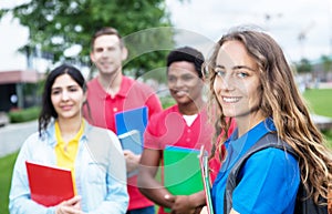 Caucasian female student with group of multiethnic students