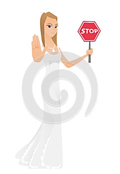 Caucasian fiancee holding stop road sign.