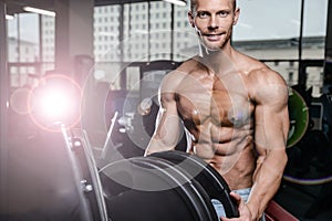 Caucasian fitness male model execute exercise with barbell