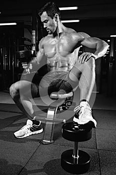 Caucasian fitness male model execute exercise with dumbbell