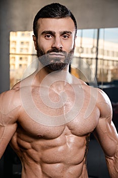 Caucasian fitness model in gym close up abs