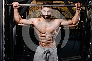 Caucasian fitness model in gym close up abs