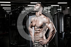 Caucasian fitness model in gym close up abs