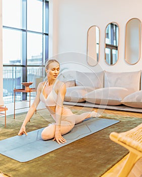 caucasian fitness woman practicing yoga at home