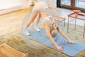 caucasian fitness woman practicing yoga at home