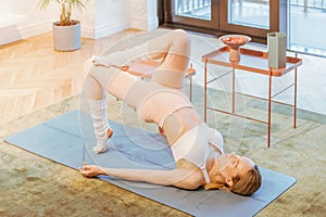 caucasian fitness woman practicing yoga at home