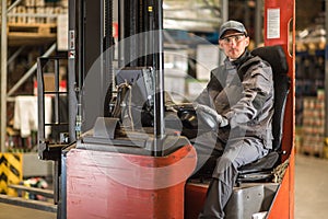 Caucasian fork lift truck driver waiting for delivery. photo