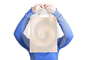 Caucasian girl with a craft package in her hands covers her face.