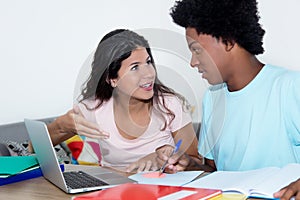 Caucasian girl learning with african american male student
