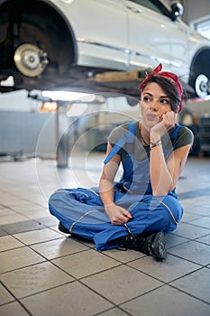 Caucasian girl mechanic working in the workshop