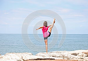 Caucasian girl performing rhythmic gymnastics exercises with the