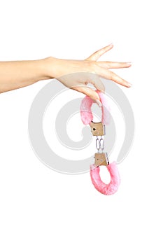 Caucasian girl`s hand holding handcuffs. Isolated