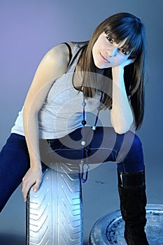 Caucasian girl standing on tyres