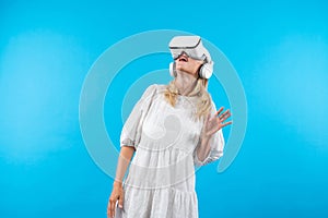 Caucasian girl with VR goggles looking around at hologram world. Contraption.