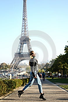 Caucasian girl walking near Eiffel Tower in Paris, France.