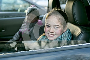 Caucasian girl in warm clothes traveling in a car