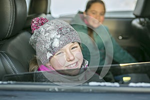 Caucasian girl in warm clothes traveling in a car